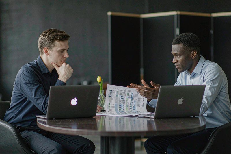 Home Two professionals comparing vendor proposals side by side